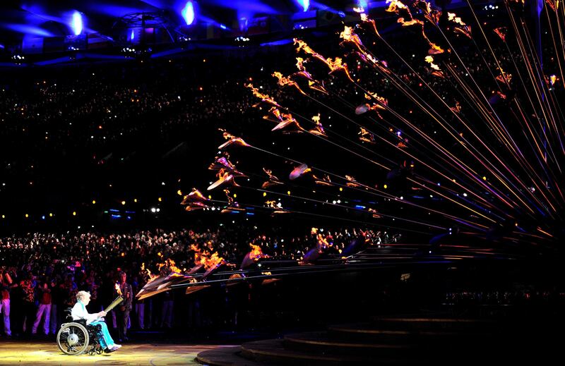 Former Paralympic archer, Margaret Maughan, lights the cauldron in the Olympic Stadium during the opening ceremony of the London 2012 Paralympic Games August 29, 2012.      REUTERS/Toby Melville (BRITAIN  - Tags: SPORT OLYMPICS)   *** Local Caption ***  JV41_PARALYMPICS-_0829_11.JPG