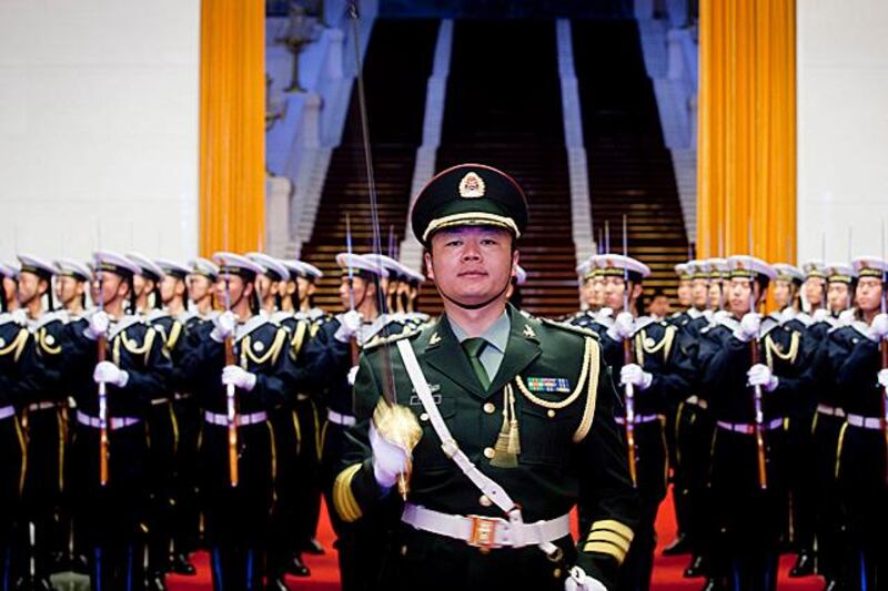 epa03012519 Members of a guard of honor of China's PLA (Peoples Liberation Army) practice before a welcoming ceremony at the Great Hall of the People in Beijing, China, 23 November 2011.  EPA/DIEGO AZUBEL