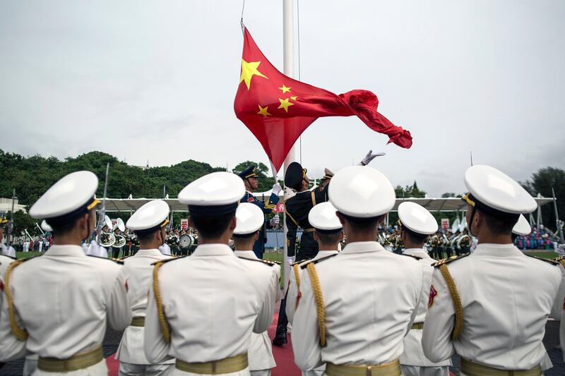 epa06083053 (FILE) - People's Liberation Army (PLA) soldiers participate in a flag raising ceremony during an open day at the PLA navy base in Hong Kong, China, 08 July 2017 (reissued 12 July 2017). According to reports, China ships carrying military personnel departed on 11 July 2017 from Zhanjiang, southern China and set sails to Djibouti. China is to establish it's fiorst ever overseas military base in the Djibouti, at the Horn of Africa.  EPA/JEROME FAVRE *** Local Caption *** 53634628