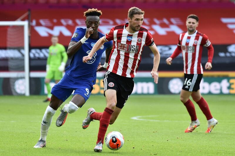 Sheffield United's Chris Basham runs with the ball past Chelsea's Tammy Abraham at Bramall Lane. AP