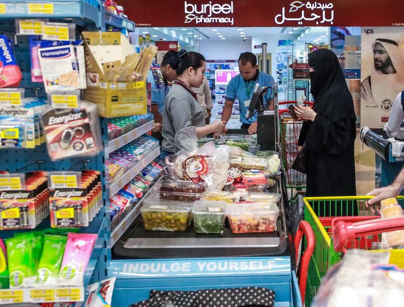 Abu Dhabi, U.A.E., June 14, 2018.  Eid al Fitr shopping at LULU Hypermarket, Mushrif Mall.  Shoppers queuing at the cashier counters.
Victor Besa / The National
Section:  National