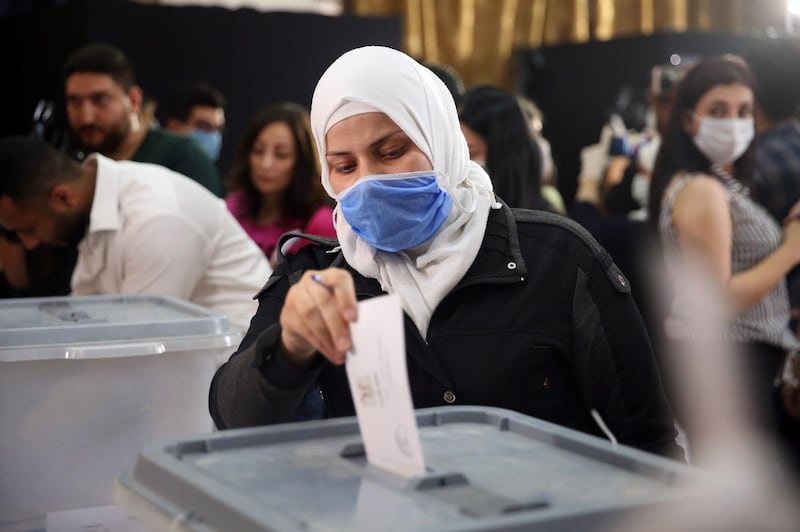 A woman casts her vote in the People's Assembly (parliament) elections in a polling station in Damascus. EPA