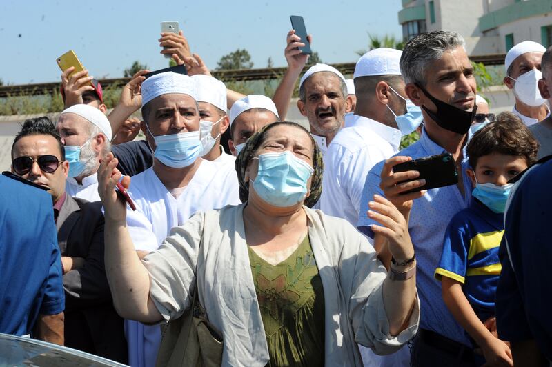 An Algerian woman cries at the time of the passage of the coffin of former president Abdelaziz Bouteflika to the El Alia cemetery in the capital Algiers, Algeria, 19 September 2021.  Former President of Algeria Abdelaziz Bouteflika died at the age of 84.   EPA