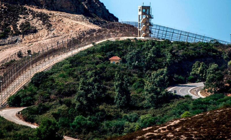 A picture shows a view of a guard tower overlooking the border fence encircling Spain's North African enclave of Ceuta which lies on the Strait of Gibraltar, surrounded by Morocco. AFP
