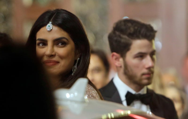 Bollywood actress Priyanka Chopra and her musician husband Nick Jonas arrive to attend the wedding of Isha Ambani, the daughter of Reliance Industries Chairman Mukesh Ambani, and Anand Piramal in Mumbai, India, Wednesday, Dec. 12, 2018. In a season of big Indian weddings, the Wednesday marriage of the scions of two billionaire families might be the biggest of them all. Isha is the Ivy League-educated daughter of industrialist Mukesh Ambani, thought to be India's richest man. The groom is the son of industrialist Ajay Piramal, thought to be worth $10 billion. (AP Photo/Rajanish Kakade)