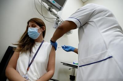 epa08906838 A woman receives a dose of the Pfizer-BioNTech COVID-19 vaccine at Zabeel Health Center in Dubai, United Arab Emirates, 27 December 2020. The Gulf emirate of Dubai has started to give the Pfizer-BioNTech COVID-19 vaccine to people on 23 December 2020.  EPA/ALI HAIDER