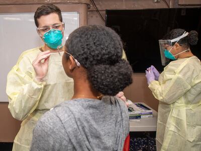 epa08341538 A handout photo made available by the US Navy shows medical staff taking a swab sample for COVID-19 testing aboard the aircraft carrier USS Theodore Roosevelt (CVN 71), at Apra Harbor, Guam, 01 April 2020 (issued 03 April 2020). According to reports on 02 April, the Navy will relieve the aircrafts carrier's Captain Brett Crozier from duty. Days earlier, Crozier had sounded the alarm about a COVID-19 coronavirus outbreak on the ship that infected some 114 sailors of the 4,865 crew members.  EPA/Dartanon D. De La Garza / US NAVY HANDOUT  HANDOUT EDITORIAL USE ONLY/NO SALES