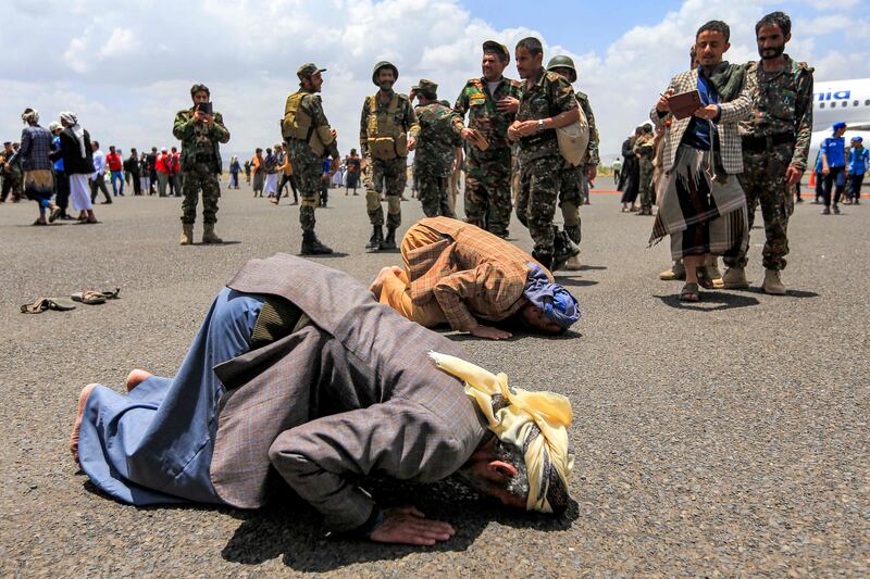 Houthi prisoners, freed under a deal between the rebels and Yemen's internationally recognised government, pray on the tarmac at Sanaa International Airport. AFP