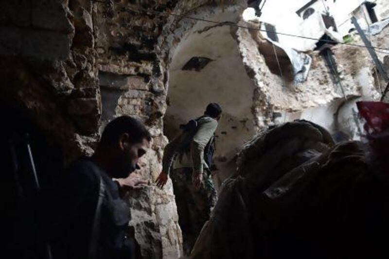 Syrian rebels walk in a damaged section of the Umayyad mosque complex in the old part of Aleppo. The rebels now control more than half of the city.