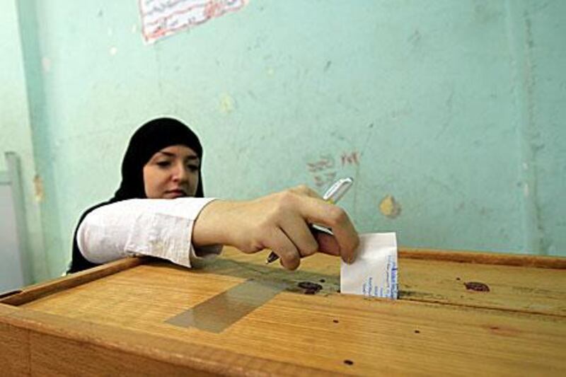 A woman casts her ballot at a polling station in Giza district near Cairo on Wednesday in the run-off of the second round of legislative election.