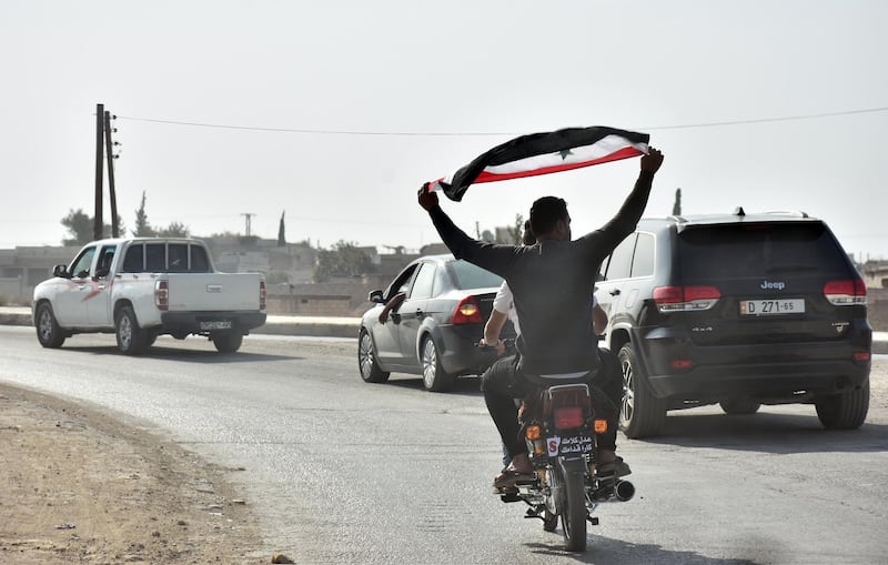 Syrian locals, carrying Syrian flags, cheer for the Syrian army in the city of Manbej and its surroundings in Aleppo provinces northeastern countryside, Syria. According to media reports, the soldiers were welcomed by the locals, who have gathered in the city center, carrying Syrian flags and cheering for the army which came to encounter the Turkish aggression.  EPA