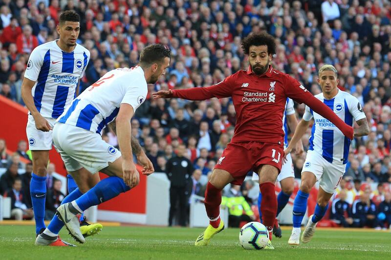 Brighton's Irish defender Shane Duffy (L) vies with Liverpool's Egyptian midfielder Mohamed Salah during the English Premier League football match between Liverpool and Brighton and Hove Albion at Anfield in Liverpool, north west England on August 25, 2018. (Photo by Lindsey PARNABY / AFP) / RESTRICTED TO EDITORIAL USE. No use with unauthorized audio, video, data, fixture lists, club/league logos or 'live' services. Online in-match use limited to 120 images. An additional 40 images may be used in extra time. No video emulation. Social media in-match use limited to 120 images. An additional 40 images may be used in extra time. No use in betting publications, games or single club/league/player publications. / 