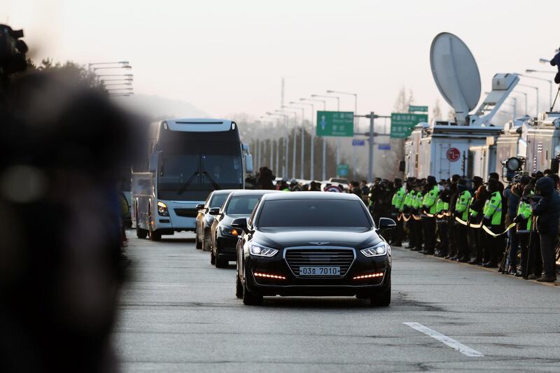 Vehicles carrying South Korean delegates pass a military check point on the Unification Bridge, linked to North Korea, near the demilitarised zone at dawn in Paju, South Korea, on Tuesday. SeongJoon Cho / Bloomberg