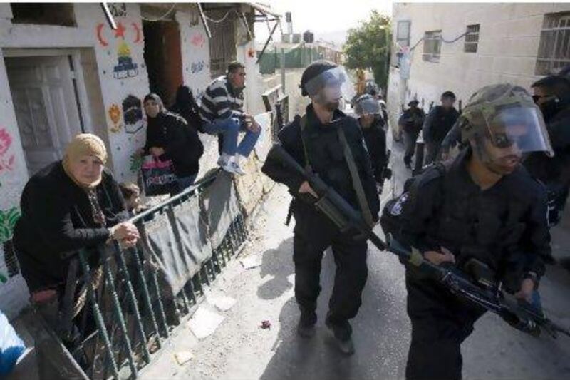 Israeli riot police file past Palestinian homes in the Ras al Amud neighborhood of East Jerusalem. Ahmad Gharabli / AFP