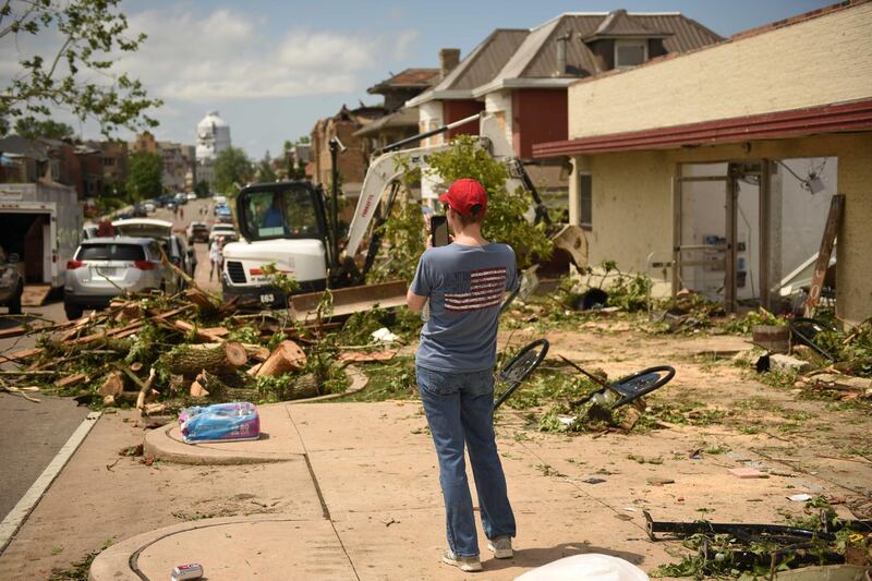 A Jefferson City resident takes photos of debris. Reuters