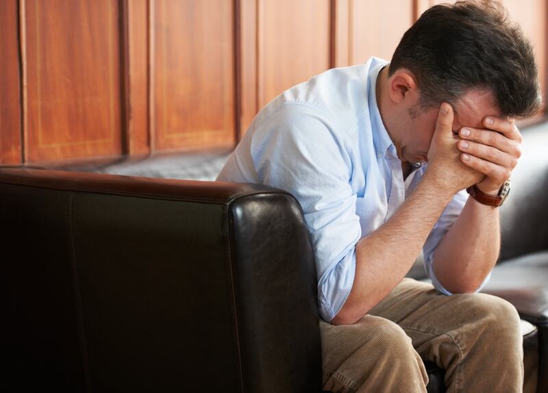 Shot of a grief-stricken man sitting on a sofa with his head in his hands (Getty Images) *** Local Caption ***  op02de-survey-depression.jpg