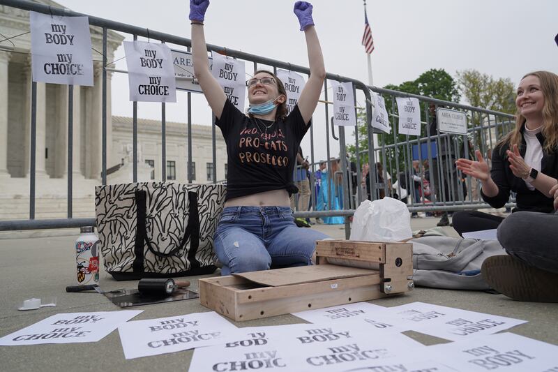 A woman makes pro-choice prints in front of the Supreme Court. Willy Lowry / The National