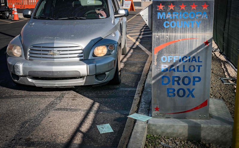 Sealed ballots are seen on the ground as a citizen drives up to drop their vote at the Maricopa County Tabulation and Election Centre on the US midterm Election Day in downtown Phoenix, Arizona. AFP