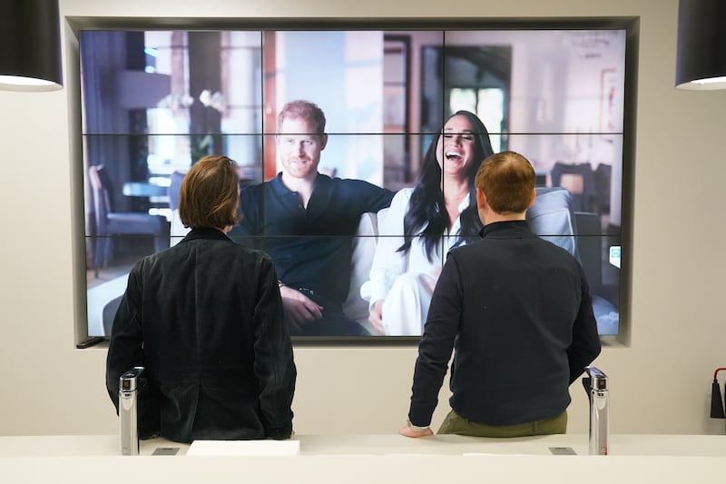 Office workers in London watching the Duke and Duchess of Sussex's controversial documentary. PA