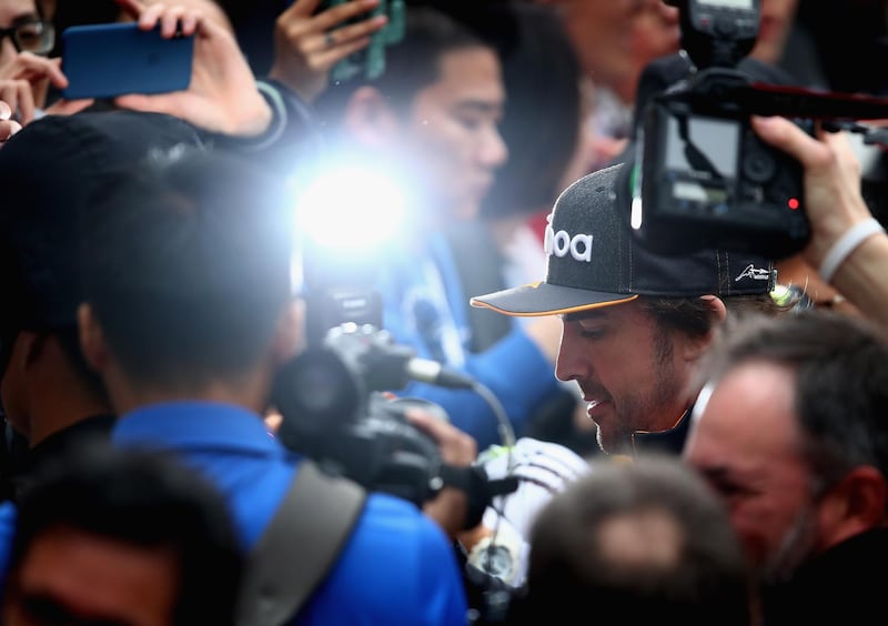 Fernando Alonso of Spain and McLaren F1 signs autographs for fans during previews ahead of the Formula One Grand Prix of China at Shanghai International Circuit. Clive Mason / Getty Images