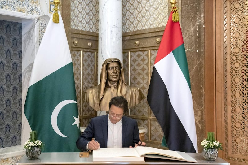 ABU DHABI, UNITED ARAB EMIRATES -November 18, 2018: HE Imran Khan, Prime Minister of Pakistan (C), signs a guest book during a reception at the Presidential Palace.

( Hamad Al Kaabi / Ministry of Presidential Affairs )?
---