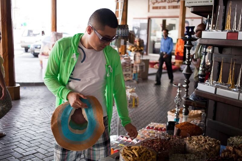 Dubai, United Arab Emirates - May 23 2013 - Chinese tourists shop for spices at the Spice Souk in Deira. STOCK. (Razan Alzayani / The National)  