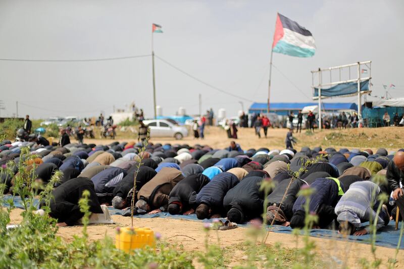 Palestinians pray during a protest marking Land Day and the first anniversary of a surge of border protests. Reuters
