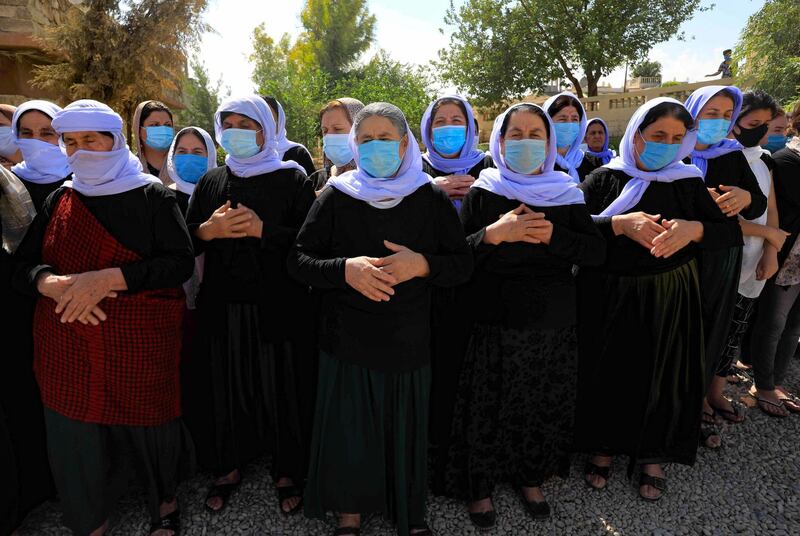 Iraqi Yazidi women attend the funeral of Baba Sheikh Khurto Hajji Ismail. AFP