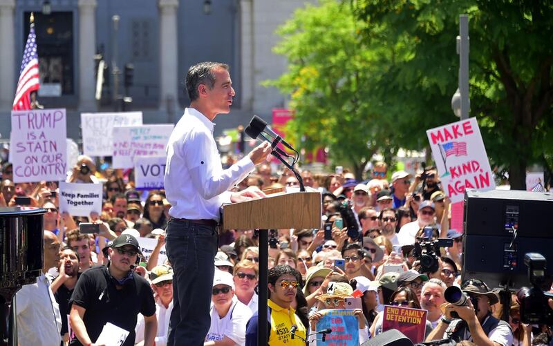 Los Angeles Mayor Eric Garcetti (C) addresses the crowd as people gather for a 'Familes Belong Together' March in Los Angeles, California on June 30, 2018 where a thousands turned out to decry the Trump administration's detention of families policy at the US Mexico border.  Thousands of demonstrators, baking in the heat and opposed to the US immigration policy, marched across the country Saturday, June 30, 2018 to protest the separation of families under President Donald Trump's hardline agenda.



 / AFP / Frederic J. BROWN
