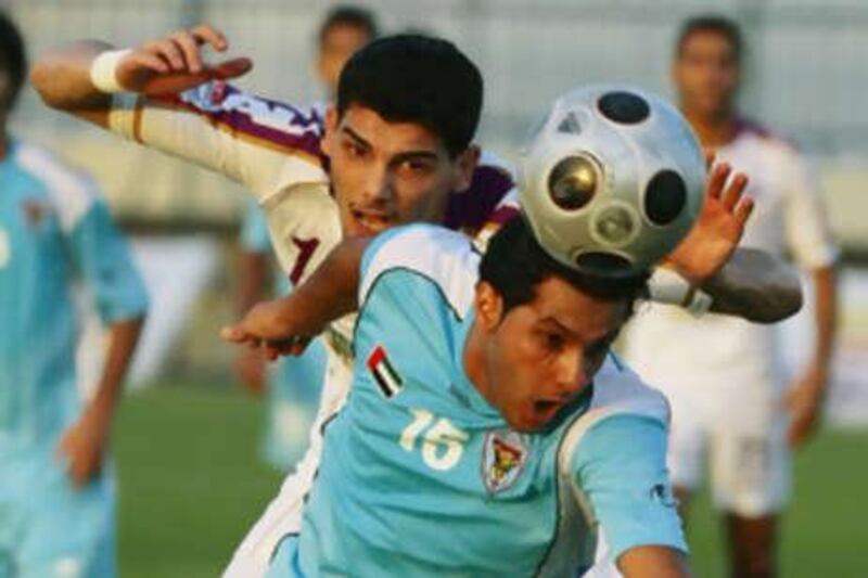 Ahmad Qadir, left, loses an aerial battle against Al Ain.