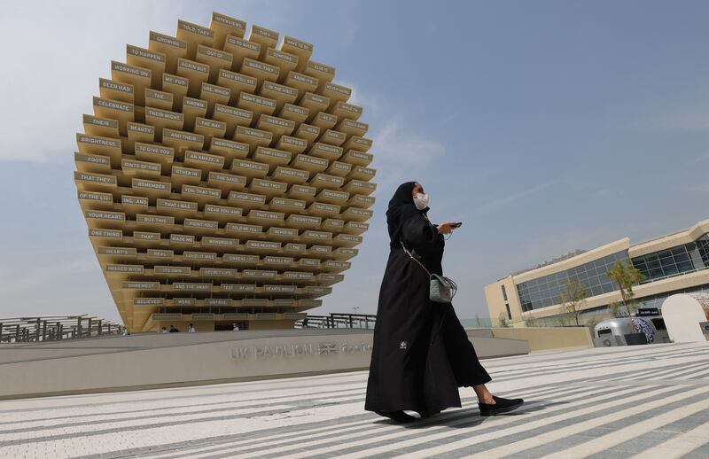 A woman walks in front of the UK pavilion. Photo: AFP