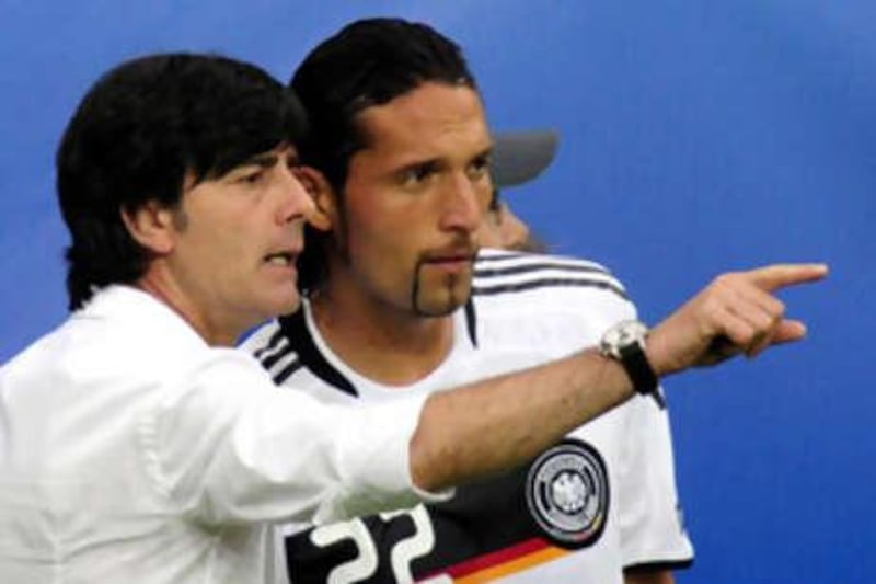 Germany's coach Joachim Loew talks passes instructions to Kevin Kuranyi during their Euro 2008 match against Croatia on June 12, 2008 at Woerthersee stadium in Klagenfurt, Austria. Loew said today he would no longer select the Schalke striker after he went absent without leave, disappearing from the stadium following Germany's 2-1 win over Russia.
