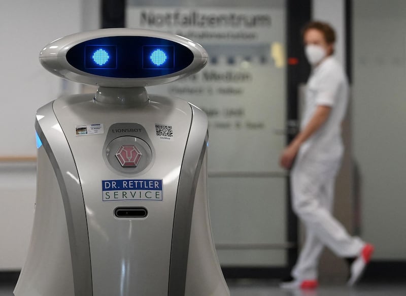 Cleaning robot 'Franzi' cleans in the entrance area of a hospital in Munich Neuperlach, southern Germany, on February 12, 2021.  Cleaning robot Franzi always makes sure the floors are spotless at the Munich hospital where she works, but she has also taken on a new role in the pandemic: cheering up patients and staff. - TO GO WITH AFP STORY BY PAULINE CURTET
 / AFP / Christof STACHE / TO GO WITH AFP STORY BY PAULINE CURTET
