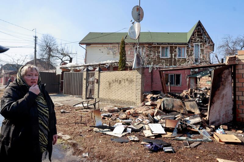 Former teacher Natalia stands near the ruins of her house which was hit in a military strike in Kyiv, Ukraine. Reuters