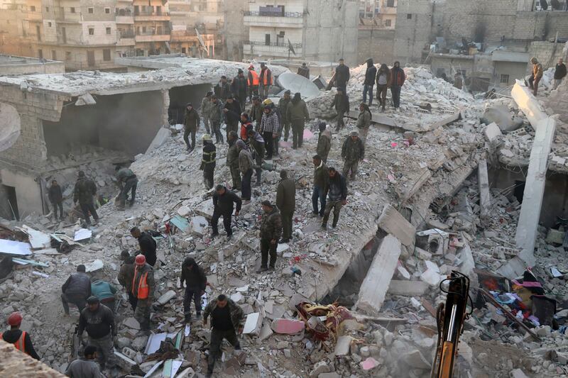 Civil defence workers and civilians search the rubble of a collapsed building in the Sheikh Maqsoud neighbourhood of Aleppo. AP