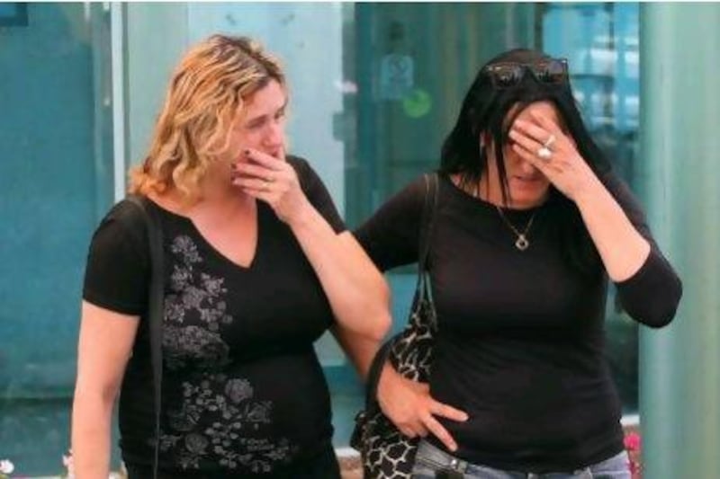 Israeli women whose relatives were among the victims of a bombing in Bulgaria wait for their arrival at the Ben Gurion airport in Tel Aviv.