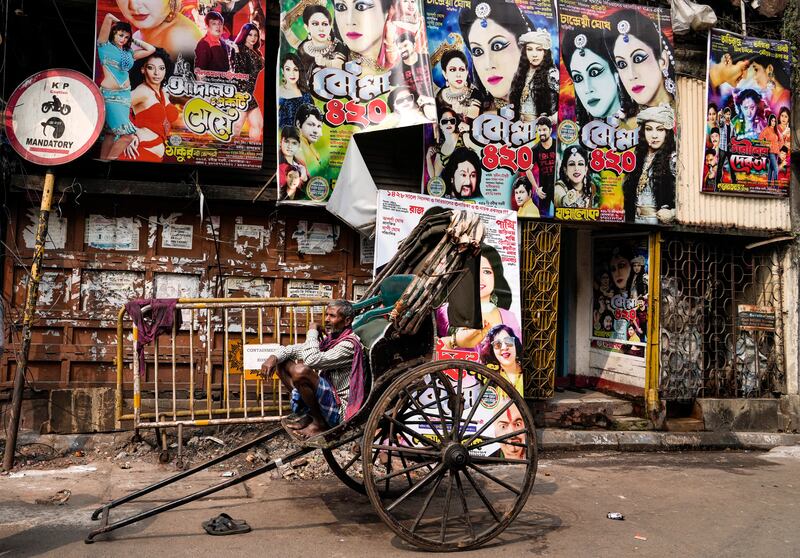 An Indian hand rickshaw puller waits for customers in Kolkata, India. AP