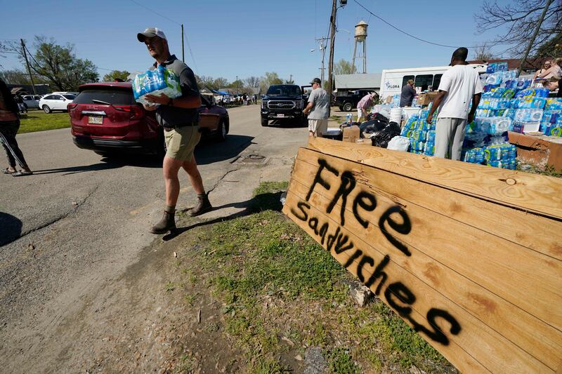 Volunteers try to help the storm-affected residents in Rolling Fork. AP