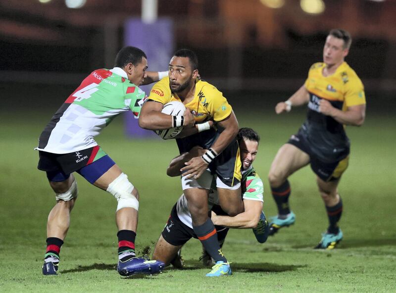 Abu Dhabi, United Arab Emirates - October 12, 2018: Hurricanes' Andrew Powell is tackled in the game between Abu Dhabi Harlequins and Dubai Hurricanes in the West Asia Premiership. Friday, October 12th, 2018 at Zayed Sports City, Abu Dhabi. Chris Whiteoak / The National