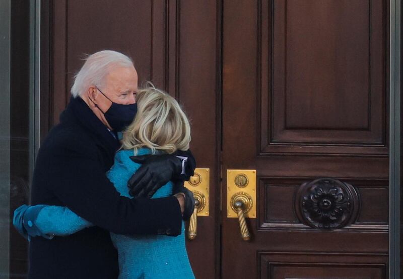 President Joe Biden and his wife Jill embrace as they arrive to the White House. Reuters