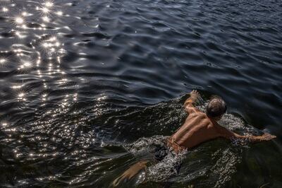 A Chinese winter swimming enthusiast swims in a cold Houhai lake in Beijing, China, December 3.  Winter swimming is popular among middle-aged and elderly citizens as they believe it can keep them in excellent health. EPA