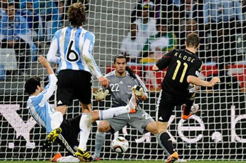 Germany's Miroslav Klose, right, celebrated his 100th cap by scoring twice yesterday.