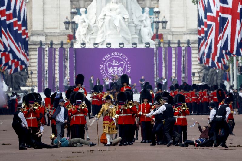 Police officers intervene as protesters try to disrupt the ceremony during the queen's platinum Jubilee celebrations on The Mall in London. Reuters