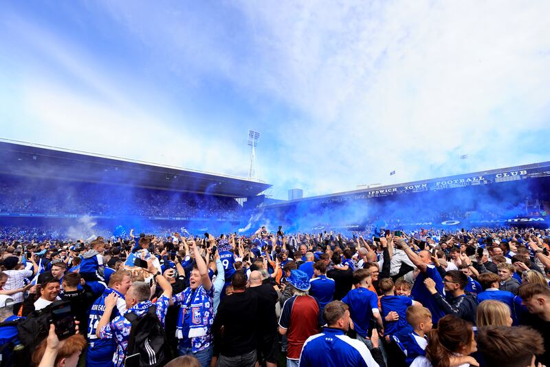 Ipswich Town supporters on the pitch after the game. Getty Images