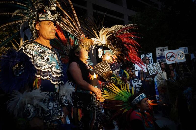 Juan Flores (left) a traditional Aztec dancer looks on during a rally in San Diego, California, in support for the protesters at Standing Rock, North Dakota who are fighting construction of the Dakota Access Pipeline. The US government last week sought to stop construction on a controversial oil pipeline in North Dakota that has angered Native Americans, blocking any work on federal land and asking the company to “voluntarily pause” work nearby. Sandy Huffaker / AFP