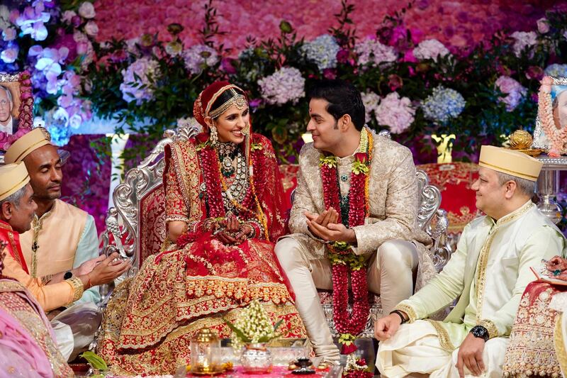 In this Saturday, March 9, 2019 photo, Akash Ambani, second right, son of Reliance Industries Chairman Mukesh Ambani and his wife Shloka Mehta smile as they perform a ritual at their wedding ceremony in Mumbai, India. Photo: Reliance Industries Limited Photo via AP
