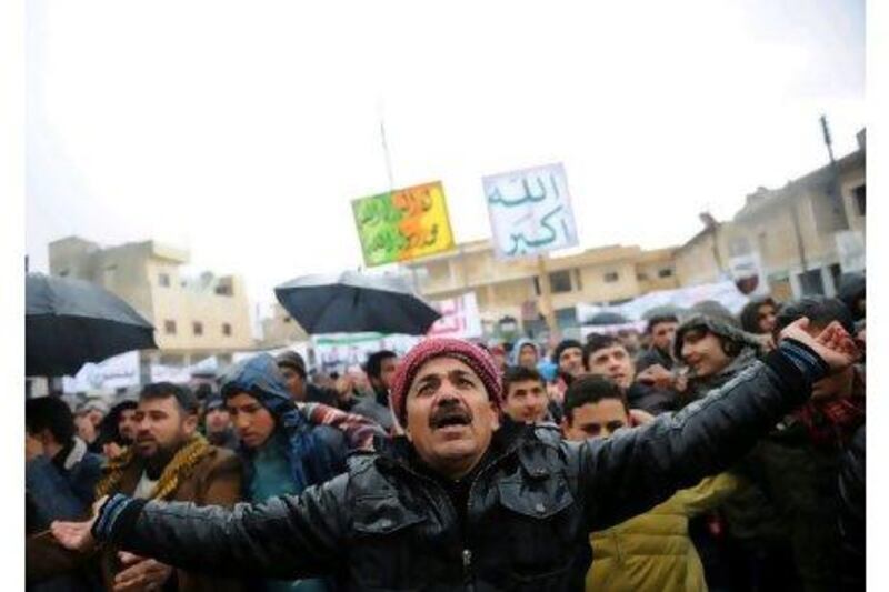 Syrians in the northern city of Idlib gather to begin demonstrating against the regime after Friday prayers yesterday.