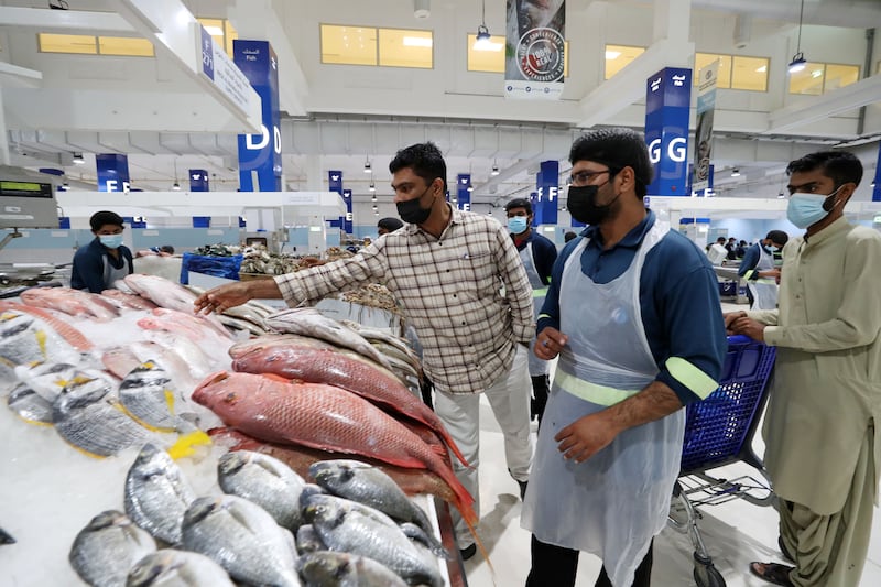 Customers shopping for fish at the Waterfront Market in Deira, Dubai. Chris Whiteoak / The National