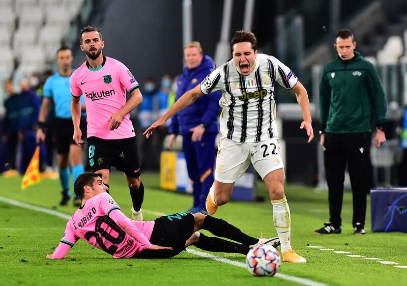 Juventus’ Federico Chiesa in action with Barcelona's Sergi Roberto. Reuters