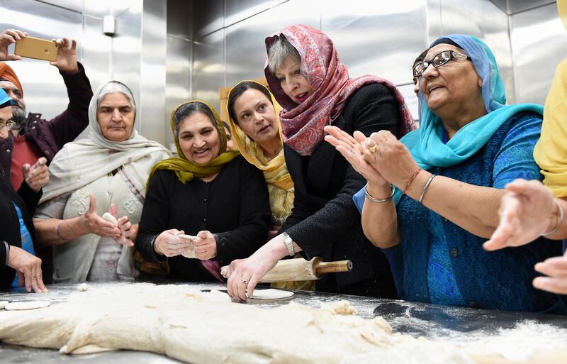 Ms May helps with food preparation during her visit to the Guru Nanak Sikh Gurdwara in Walsall to mark Vaisakhi in April 2018